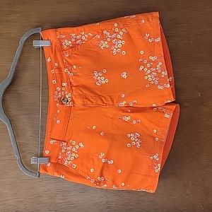 A.n.a size 6 twill short vibrant orange with pink, yellow and blue flowers.